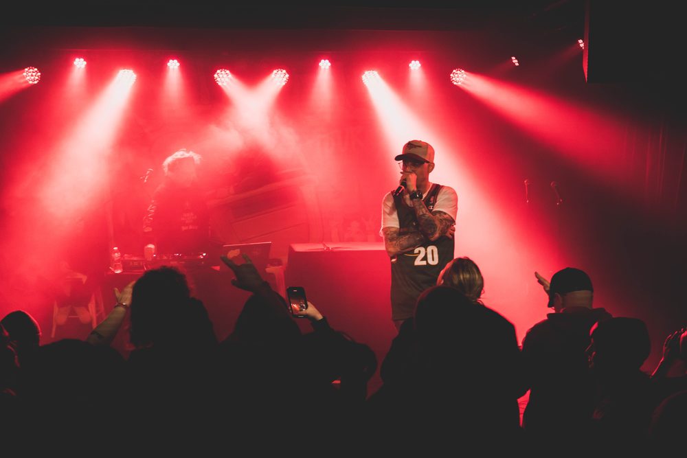 Marley B. performing under stage lights